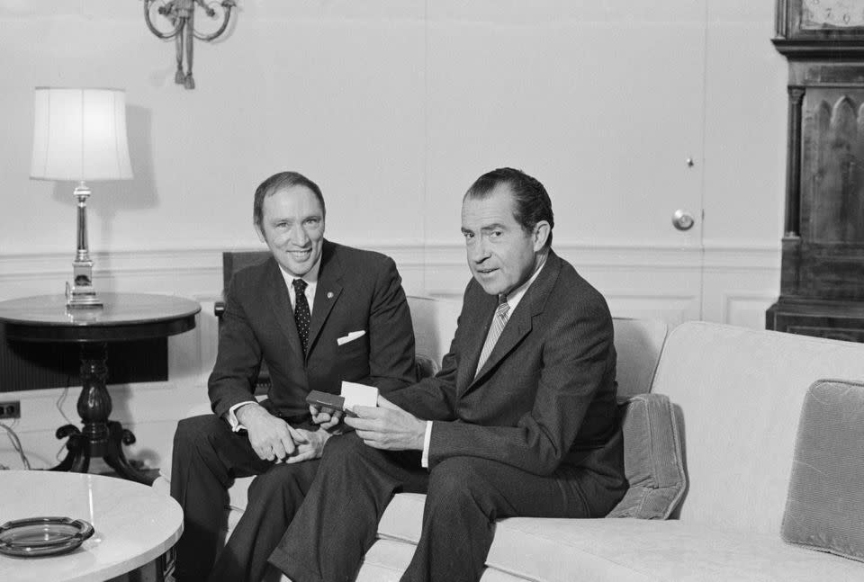 Archive photo of prime minister Pierre Trudeau and U.S. president Richard Nixon posing for picture on a sofa in the Chief Executive's office on March 24, 1969.