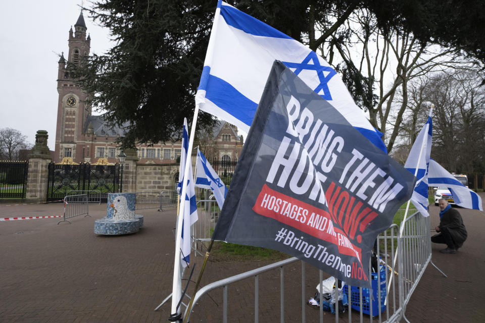 Israeli flags outside the United Nations' highest court, rear left, during historic hearings in The Hague, Netherlands, Wednesday, Feb. 21, 2024, into the legality of Israel's 57-year occupation of the West Bank and east Jerusalem, plunging the 15 international judges back into the heart of the decades-long Israeli-Palestinian conflict. Six days of hearings at the International Court of Justice, during which an unprecedented number of countries will participate in proceedings, are scheduled as Israel continues its devastating assault on Gaza. (AP Photo/Peter Dejong)