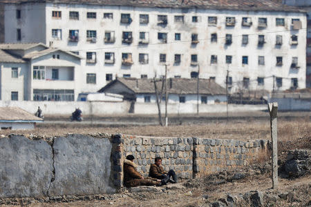 Men rest on the North Korean side of the Yalu River north of the town of Sinuiju, North Korea, March 31, 2017. REUTERS/Damir Sagolj