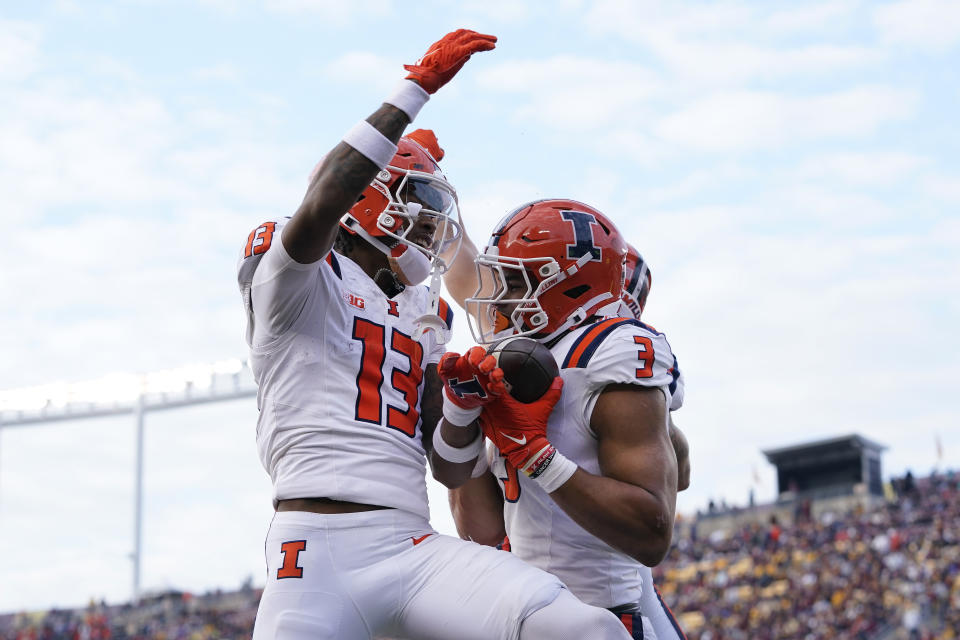 Illinois running back Kaden Feagin (3) celebrates with teammates after scoring a 54-yard touchdown against Minnesota during the second half of an NCAA college football game Saturday, Nov. 4, 2023, in Minneapolis. (AP Photo/Abbie Parr)