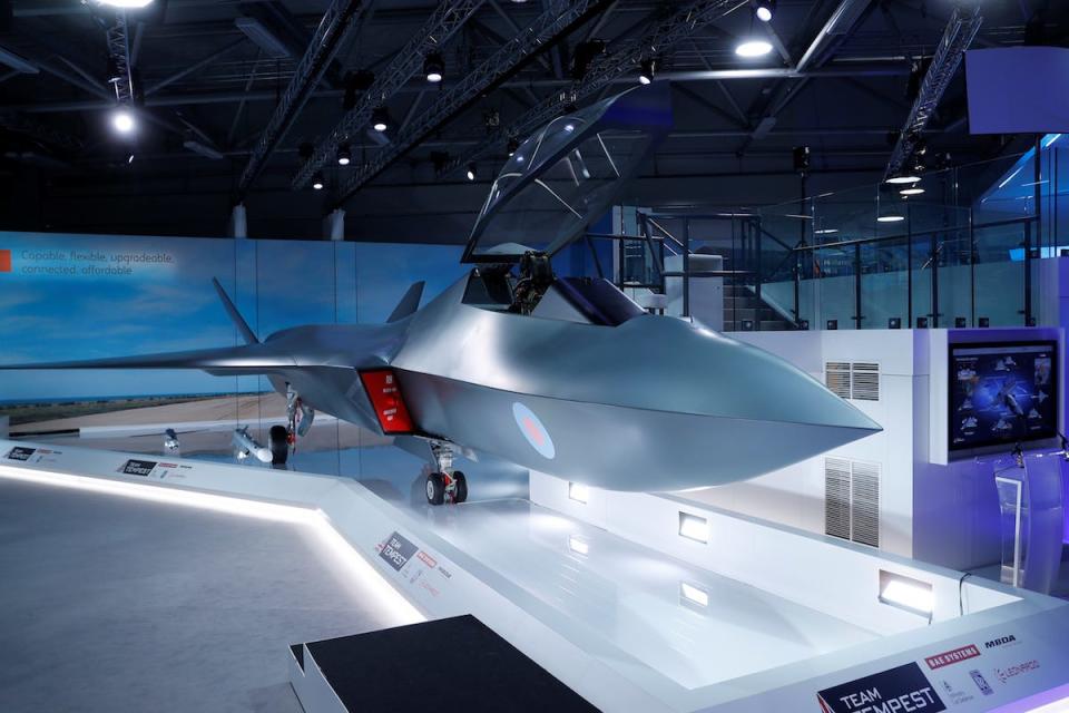 A model of a Tempest, a sleek-looking fighter jet with grey coloring, with its canopy up in an unveiling hall.