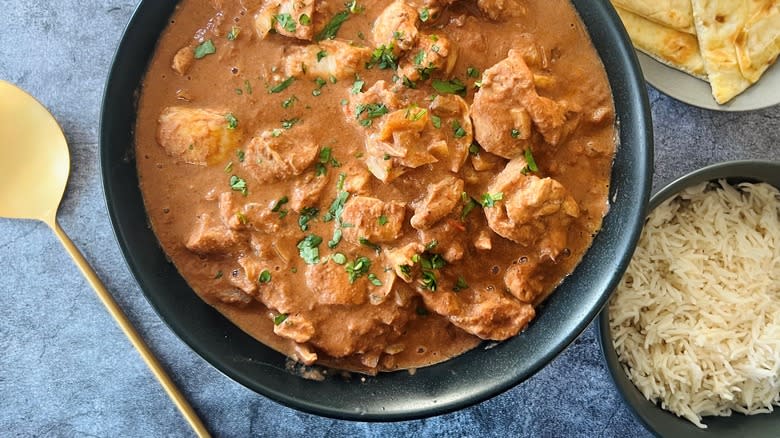 butter chicken in black bowl