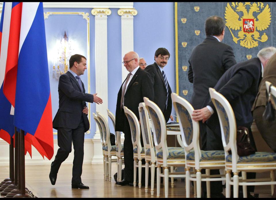 Russian President Dmitry Medvedev, left, shakes hands with Mikhail Fedotov, second left, the head of Russia's presidential human rights in the Gorki residence outside Moscow on Saturday, April 28, 2012. Medvedev's human rights council reported to him for the last time before he leaves office on May 7. The council has previously recommended that he pardon jailed oil tycoon Mikhail Khodorkovsky and could do so again, but Medvedev has made clear he will not do so unless Khodorkovsky acknowledges his guilt. (AP Photo/RIA-Novosti, Yekaterina Shtukina, Presidential Press Service)