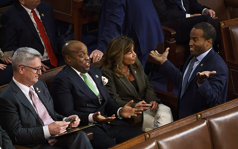 Rep.-elect Wesley Hunt (R-Texas), second to left, reacts to a comment from Rep.-elect John James (R-Mich.), right, during the ninth ballot for Speaker on Jan. 5. <em>Greg Nash</em>