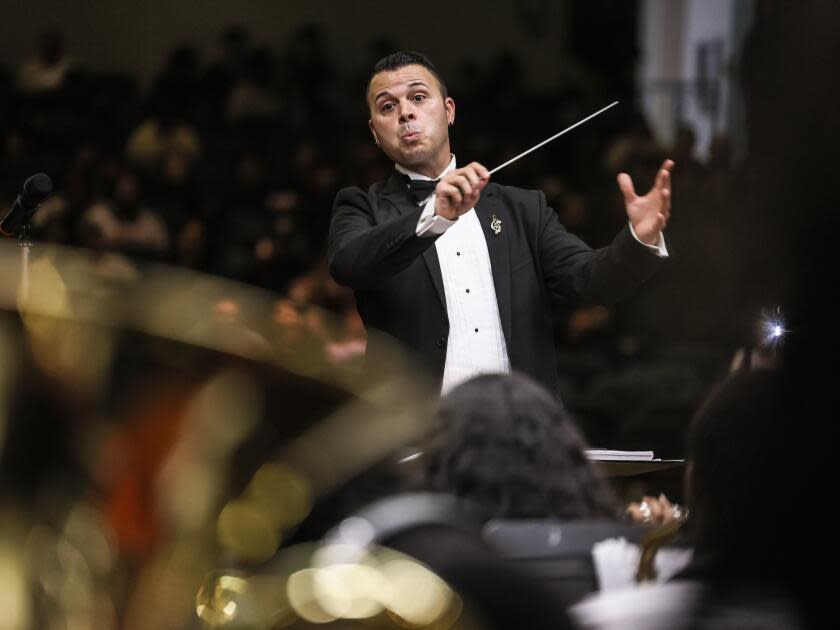 The band director at Inglewood High School, Joseph Jauregui, conducts during a performance.