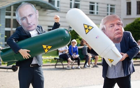 Anti-nuclear protesters wear masks of US President Donald Trump and Russian President Vladimir Putin  - Credit: OMER MESSINGER/EPA-EFE/REX