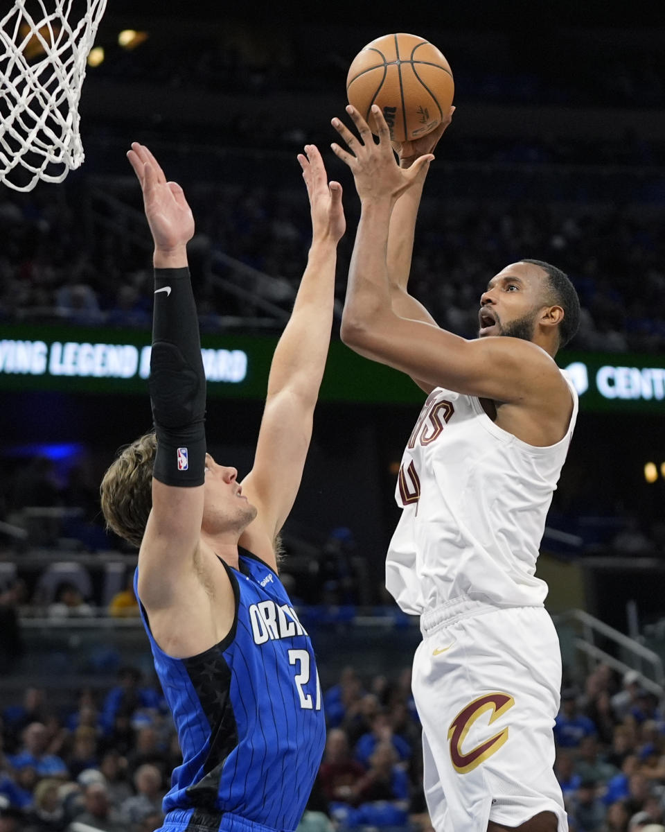 Cleveland Cavaliers forward Evan Mobley, right, shoots over Orlando Magic center Moritz Wagner during the first half of Game 3 of an NBA basketball first-round playoff series Thursday, April 25, 2024, in Orlando, Fla. (AP Photo/John Raoux)