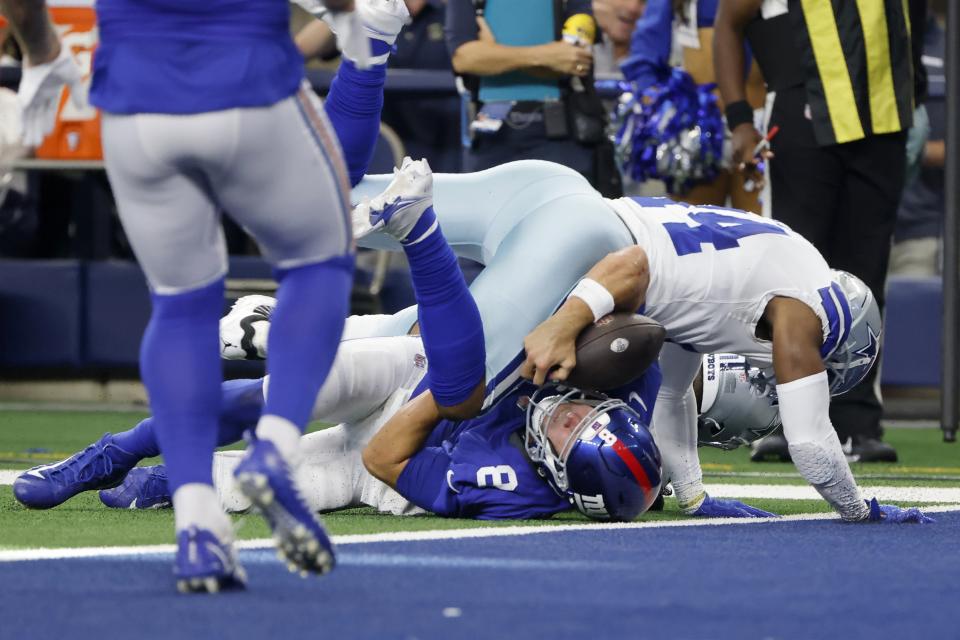 Dallas Cowboys linebacker Jabril Cox (14) tackles New York Giants quarterback Daniel Jones (8) short of the end zone in the first half of an NFL football game in Arlington, Texas, Sunday, Oct. 10, 2021. Jones left the game with an unknown injury. (AP Photo/Michael Ainsworth)