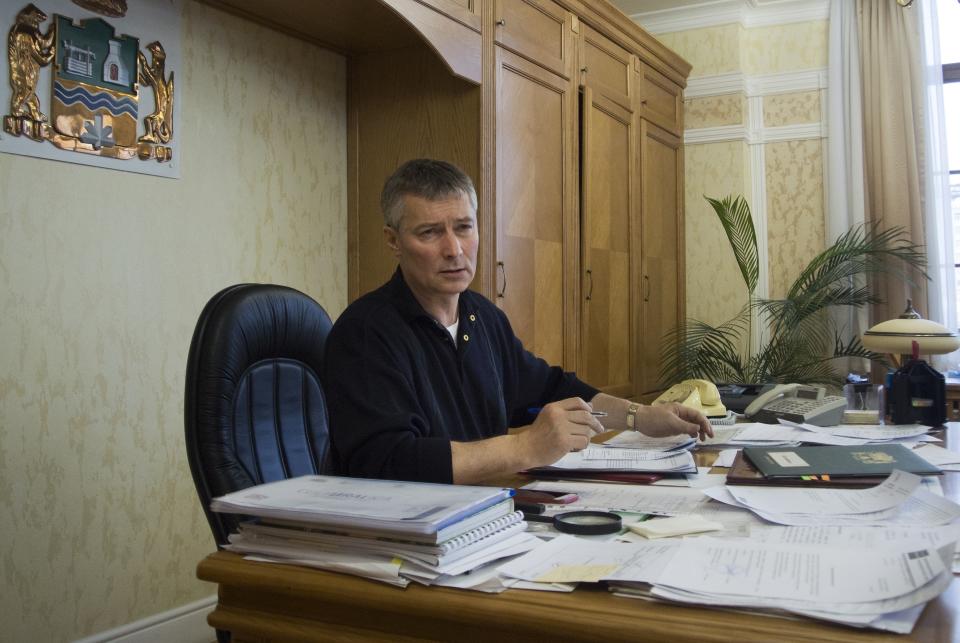 FILE Yekaterinburg mayor Yevgeny Roizman talks to The Associated Press in his office in Yekaterinburg, Russia on Monday, Feb. 12, 2018. Roizman, the former mayor of Yekaterinburg and one of Russia's most visible and charismatic opposition figures, stood trial for discrediting the military, a charge that could bring a prison sentence. But the prosecutor on Thursday called for him to be fined 260,000 rubles ($3250), suggesting he could avoid prison time. (AP Photo/Nataliya Vasilyeva, File)