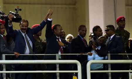 Eritrea's President Isaias Afwerki and Ethiopian Prime Minister Abiy Ahmed hold hands during a concert at the Millennium Hall in Addis Ababa, Ethiopia July 15, 2018. REUTERS/Tiksa Negeri