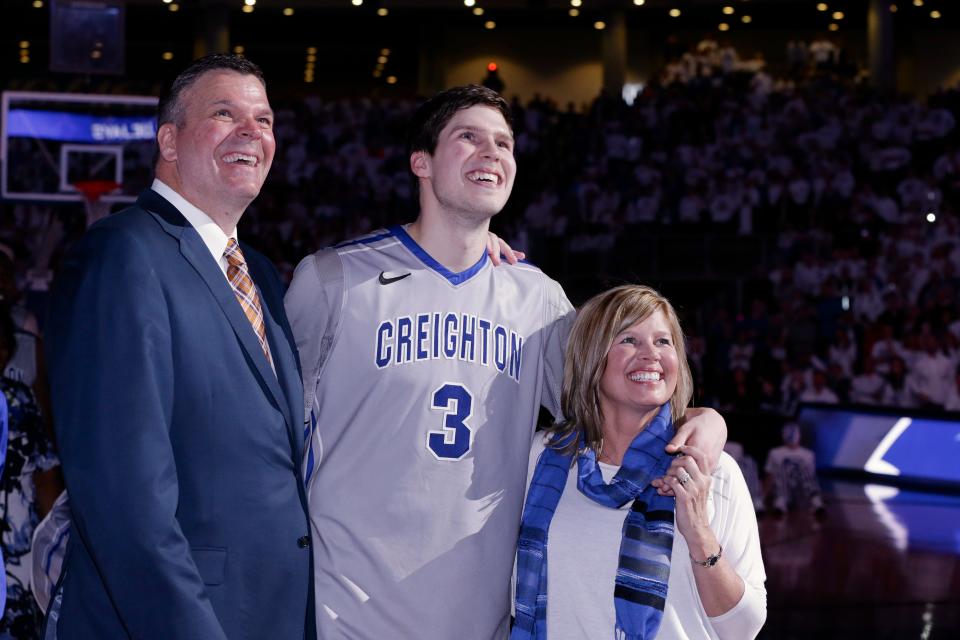 Creighton's Doug McDermott, center, stands with his father, Creighton coach Greg McDermott and his mother Theresa,  at CenturyLink Arena during a senior night ceremony.