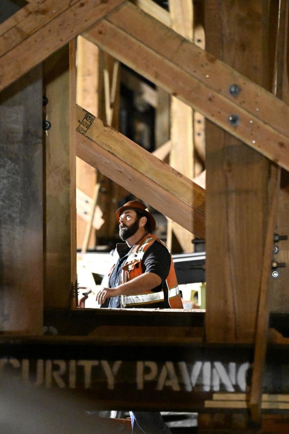 A construction worker looks up on the freeway.