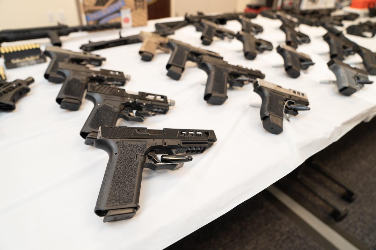 Seized guns are on display at a press conference about seized ghost guns at the Queens District Attorney's office in Queens, New York.