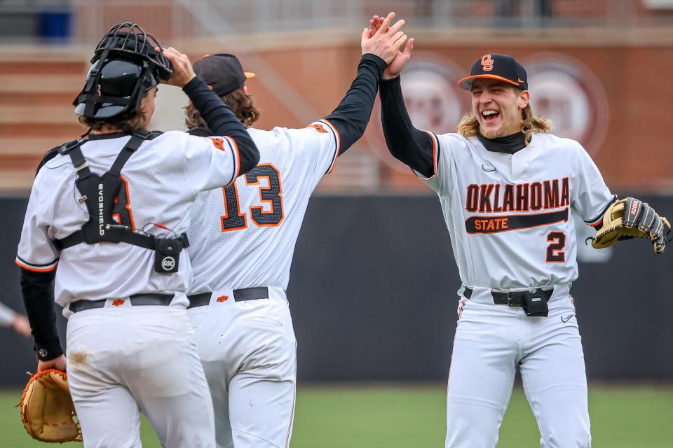 Oklahoma State's Aidan Meola, right, high-fives Nolan McLean celebrate after defeating Loyola Marymount at O’Brate Stadium in Stillwater on Saturday.