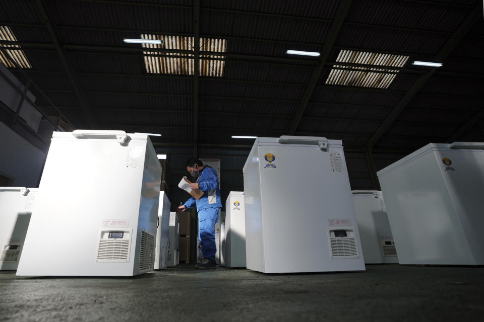 Brand-new ultralow-temperature freezers are seen at warehouse at Kanou Reiki, a freezer supplier, on Friday, Jan. 22, 2021 in Sagamihara, west of Tokyo. Some of COVID-19 vaccine must be kept at the ultra-cold temperature of around -70 degrees Celsius (-94 degrees Fahrenheit). Japan is accelerating preparations for COVID-19 vaccinations in hopes of starting them in late February, but uncertainty is growing as the country faces vaccine-shy public, slow approval process and bureaucratic roadblocks, casting a doubt if Tokyo Olympic this summer is possible. (AP Photo/Eugene Hoshiko)