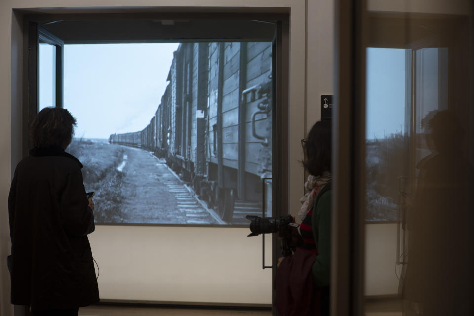 People look at historic footage of trains carrying Jews to Nazi concentration camps during a press preview of the new National Holocaust Museum in Amsterdam, Netherlands, Tuesday, March 5, 2024. (AP Photo/Peter Dejong)