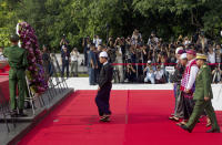 Myanmar President Win Myint, front, walks to lay flower wreath along with, from right back row, Military Chief Senior Gen. Min Aung Hlaing, Upper House Speaker Mann Win Khaing Than, Vice President Mint Swe, Lower House Speaker T Khun Myat, and Myanmar Chief Justice Tun Tun Oo, at the tomb of Myanmar's independence hero Gen. Aung San during a ceremony to mark the 72nd anniversary of his 1947 assassination, at the Martyrs' Mausoleum Friday, July 19, 2019, in Yangon, Myanmar. The country's Independence hero Gen. Aung San and his cabinet were gunned down in 1947. (AP Photo/Thein Zaw)