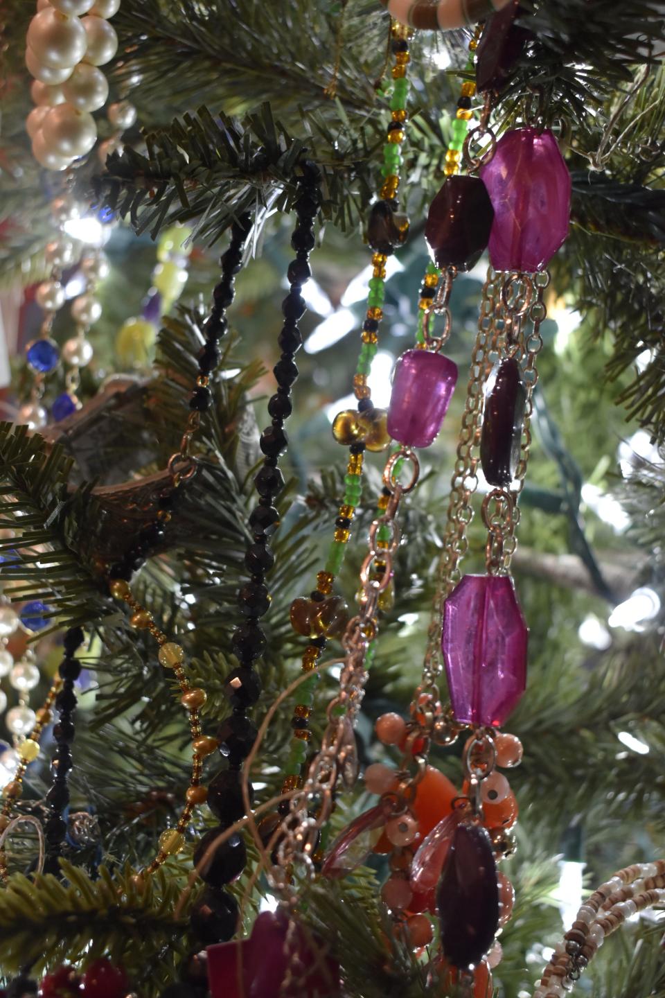 A Christmas tree at Spencer's CommUnity Center on the Owen County Courthouse Square is decorated with vintage jewelry for sale.
