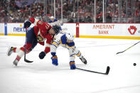 Florida Panthers defenseman Niko Mikkola (77) and Buffalo Sabres center Dylan Cozens (24) collide during the second period of an NHL hockey game, Saturday, April 13, 2024, in Sunrise, Fla. (AP Photo/Lynne Sladky)