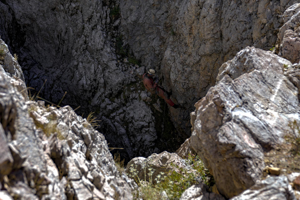 A European Cave Rescue Association (ECRA) member, goes down into the Morca cave during a rescue operation near Anamur, south Turkey, Friday, Sept. 8, 2023. American researcher Mark Dickey, 40, who fell ill almost 1,000 meters (more than 3,000 feet) below the entrance of a cave in Turkey, has recovered sufficiently enough to be extracted in an operation that could last three or four days, a Turkish official was quoted as saying on Friday. (AP Photo/Khalil Hamra)