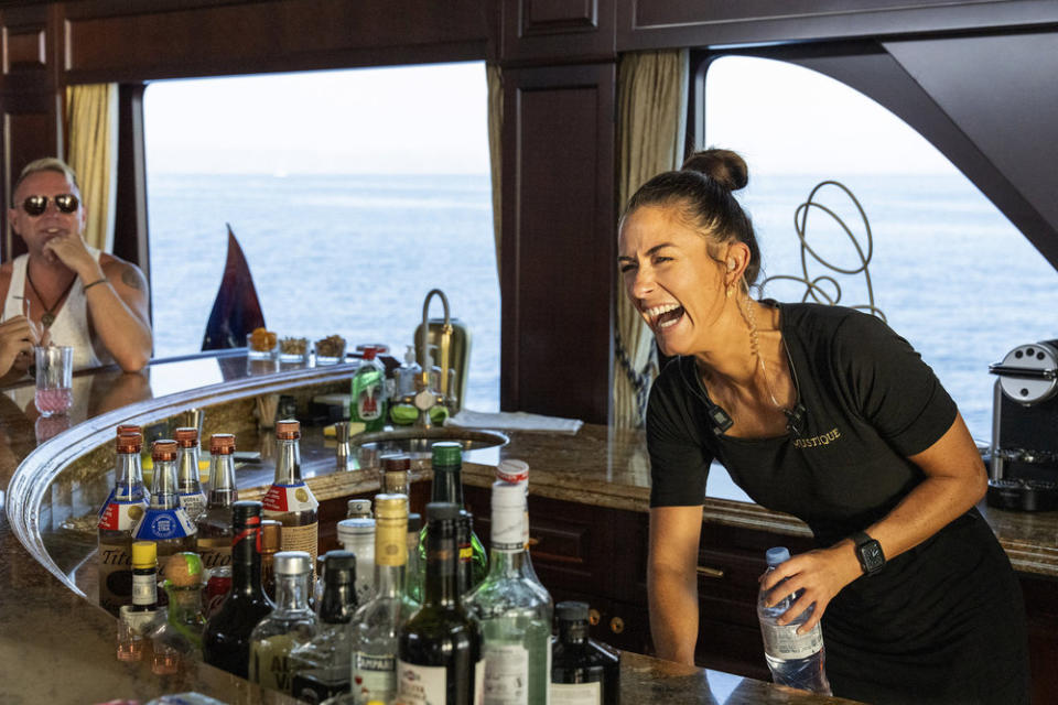 Chief Stew Aesha Scott serves drinks on a Below Deck Med charter. 