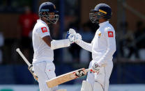 Cricket - England v Sri Lanka, Third Test - Colombo, Sri Lanka - November 24, 2018. Sri Lanka's Dimuth Karunaratne and Dhananjaya de Silva celebrate their partnership. REUTERS/Dinuka Liyanawatte