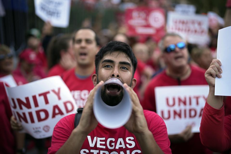 FILE - Members of the Culinary Workers Union rally along the Las Vegas Strip, Thursday, Aug. 10, 2023, in Las Vegas. New gadgets on display this week at CES 2024 put a spotlight on technology and artificial intelligence a little more than a month after the Culinary Workers Union ratified new contracts for 40,000 members, ending a bitter, high-profile fight between Strip casinos and the union workers supporting the city's economic backbone. (AP Photo/John Locher, File)