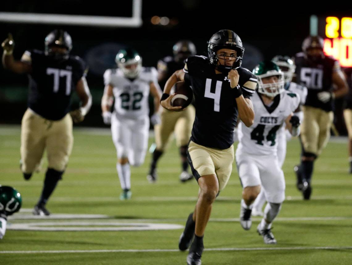 Fossil Ridge quarterback Logan Cundiff (4) leads the crowd upfield in the second half of a high school football game at Keller ISD Stadium in Keller, Texas, Thursday, Sept. 08, 2022. Keller Fossil Ridge defeated Arlington High School 39-34. (Special to the Star-Telegram Bob Booth)