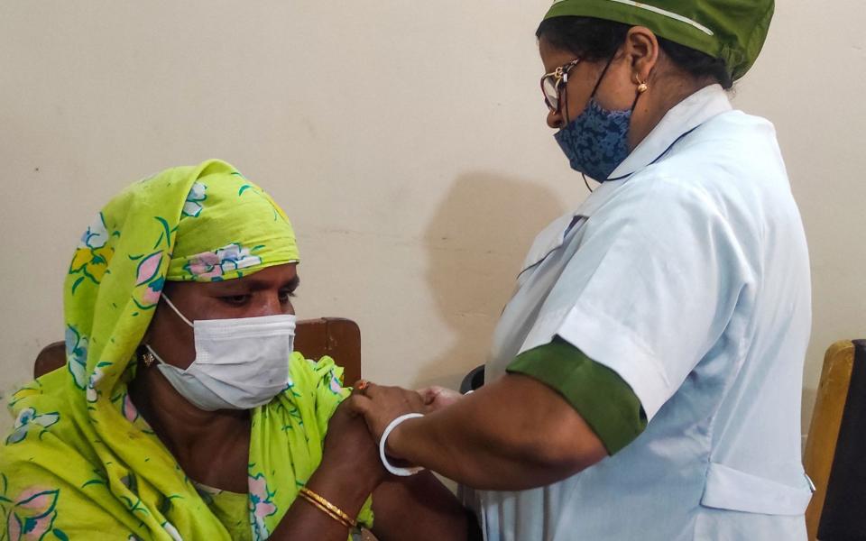 A sex worker from Bangladesh's largest brothel receives a dose of a Covid-19 vaccine in Daulatdia - AFP