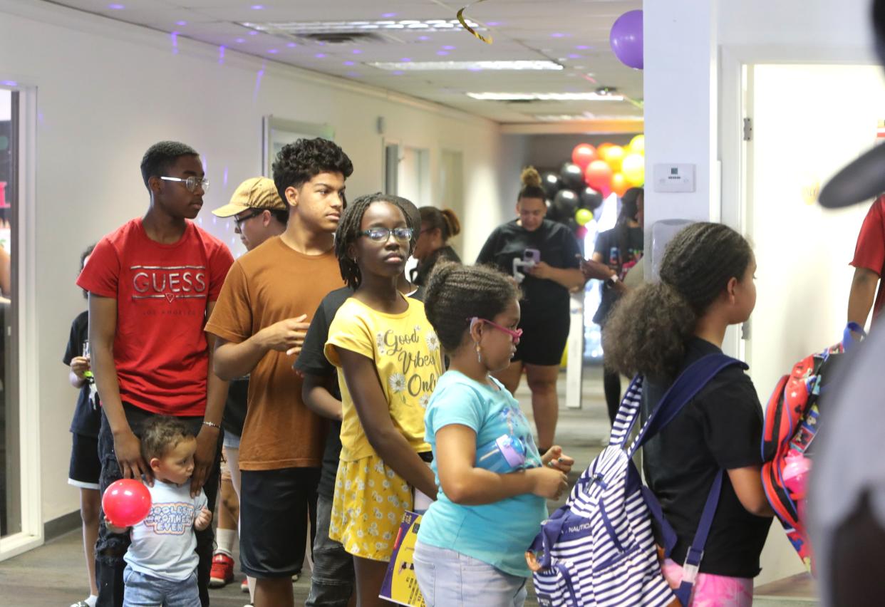 People line up for free school supplies at the Innovative Minds Behavioral Health and Live Love Dance Incorporated back-to-school event in Phoenix on July 22, 2023.