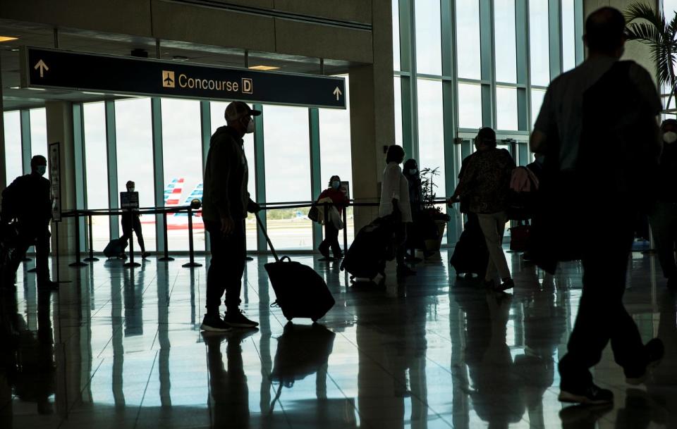 Travelers move through Southwest Florida International Airport on Tuesday, January 26, 2021. Many Asian Americans in Florida are concerned about a new law, SB 264, that went into effect July 1. It prohibits seven foreign countries and foreign principals tied to those nations from buying a wide range of real estate, including property within 10 miles of a military installation or critical infrastructure facility such as an airport. (Credit: Andrew West/The News-Press, The News-Press)