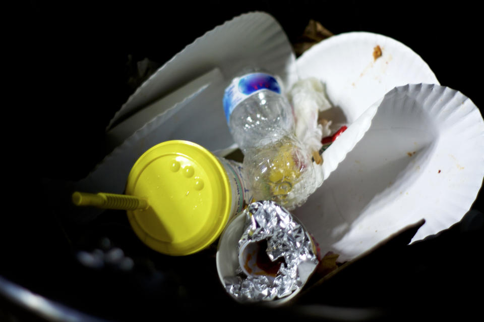 paper plates in a trash can