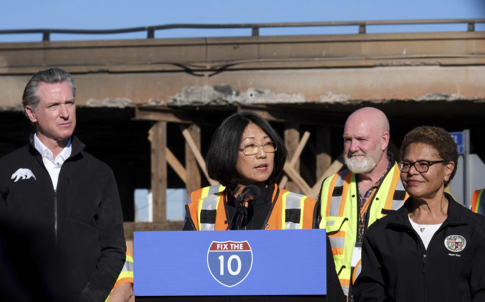 Caltrans District 7 Director Gloria Roberts, center, along with Gov. Gavin Newsom, left, and Los Angeles Mayor Karen Bass, right,, speaks during a news conference about repairs for a stretch of Interstate 10, Tuesday morning Nov. 14, 2023, in Los Angeles. It will take at least three weeks to repair the Los Angeles freeway damaged in an arson fire, the Newsom said Tuesday, leaving the city already accustomed to soul-crushing traffic without part of a vital artery that serves hundreds of thousands of people daily. (Dean Musgrove/The Orange County Register via AP)