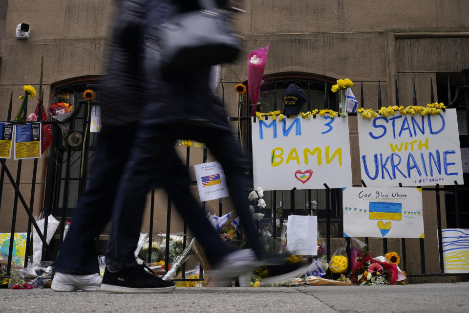 Signs and flowers of support adorn the gates of the Ukrainian Mission to the United Nations in New York, Tuesday, March 1, 2022. (AP Photo/Seth Wenig)