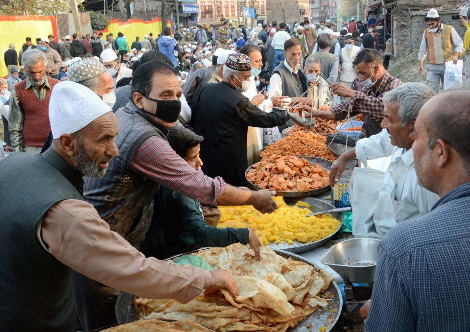 People buy snacks from roadside vendors outside the Naqshband Sahib Shrine, in Srinagar, Wednesday, 21 October, 2020. Thousands of Kashmiri Muslims gathered to offer traditional Khawaja Digar special mass prayers to mark the Urs of Sufi Saint Khwaja Naqshband Sahib at his Shrine in Khawaja Bazar Downtown Srinagar.