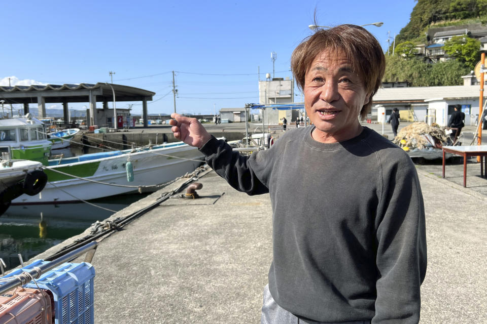 CORRECTS PORT'S NAME - Masaki Nishide, a fisherman at the Saikazaki port, describes the explosion scene Sunday April 16, 2023 at an election campaign event Prime Minister Fumio Kishida attended and narrowly escaped in Wakayma, western Japan. (AP Photo/Johnson Lai)