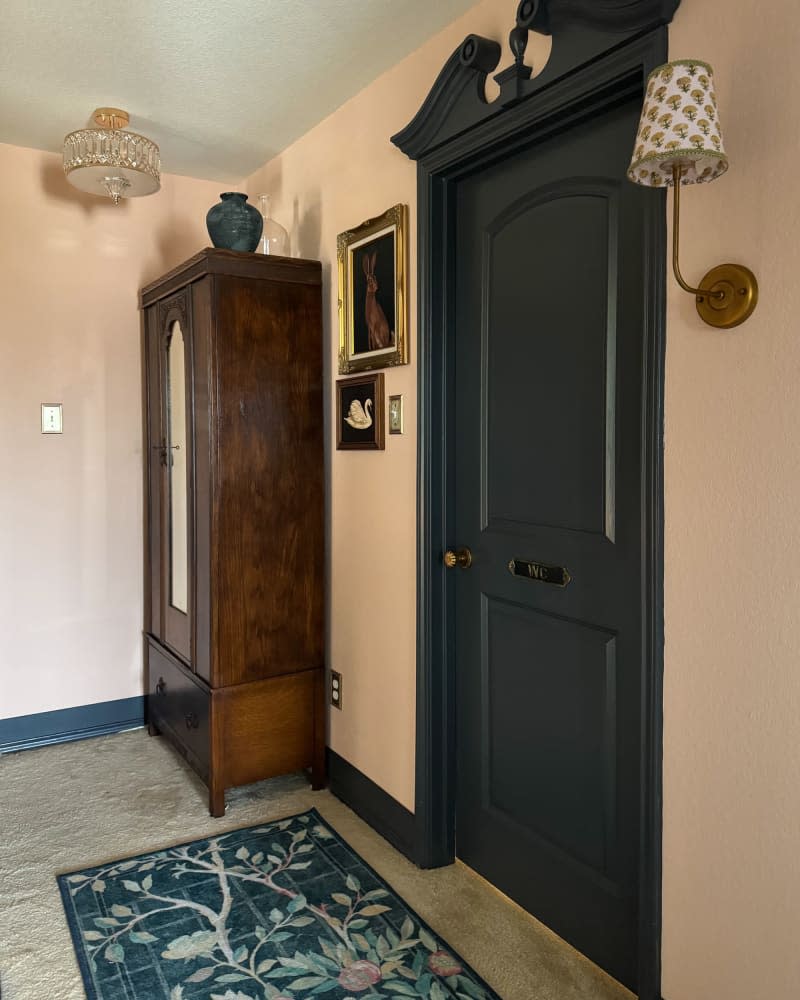 Deep blue door with ornate curved trim at the top after makeover