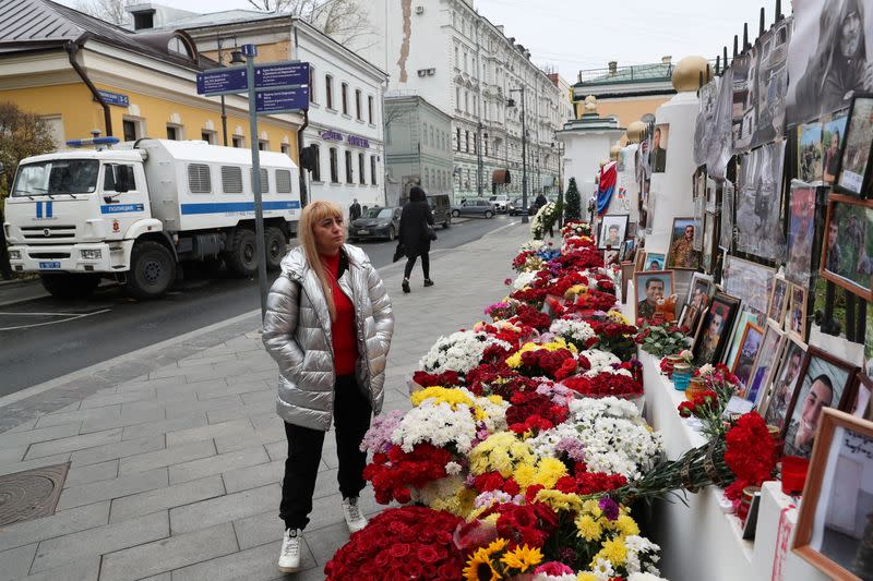 A woman stands next to a makeshift memorial outside the Armenian embassy for people killed during a military conflict over the breakaway region of Nagorno-Karabakh in Moscow