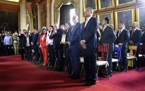 Member of the Constituent Assembly Diosdado Cabello (C) delivers a speech next to first lady Cilia Flores and other Assembly's members, during its installation at the National Congress - Credit: AFP