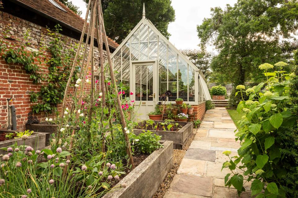 8. Embrace classic charm with a greenhouse