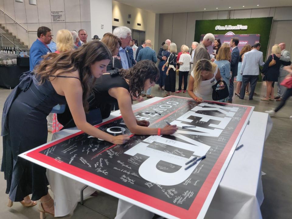 Brian Kemp supporters sign a commemorative poster at the Georgia governor's primary victory party May 24 in Atlanta, Georgia.