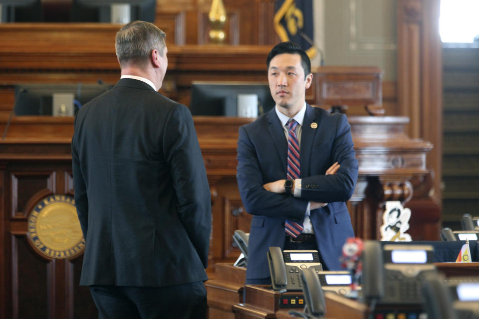 Kansas state Rep. Rui Xu, D-Westwood, talks with House Majority Leader Chris Croft, R-Overland Park, after the House adjourned for the day, Wednesday, Feb. 7, 2024, at the Statehouse in Topeka, Kan. A 93% pay raise for lawmakers is set to take effect next year because neither chamber approved a resolution to reject it. (AP Photo/John Hanna)