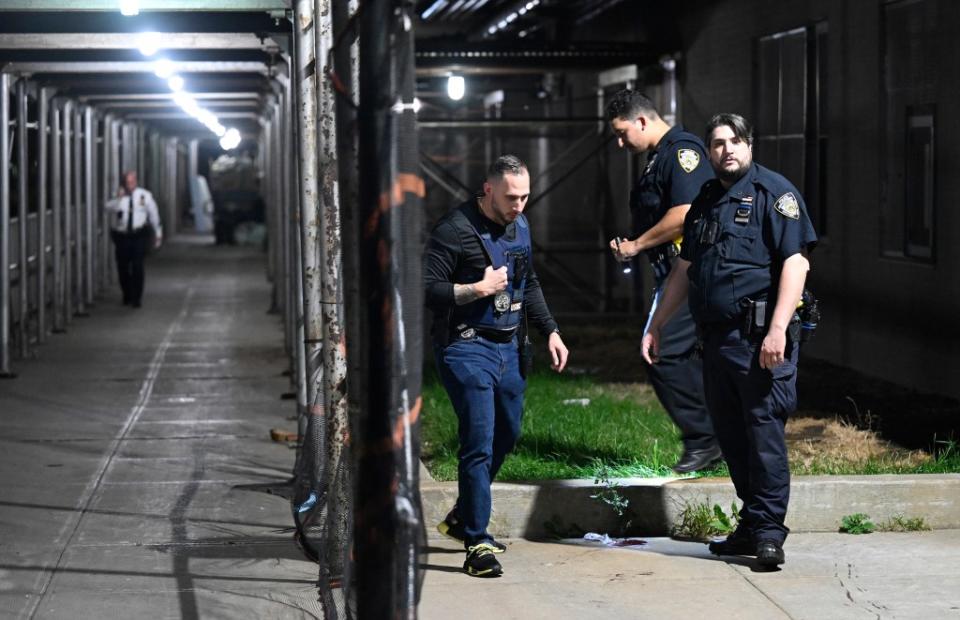 Police examine a blood stain found on the sidewalk outside the apartment where Rae’Lynn was killed in 2022 Paul Martinka