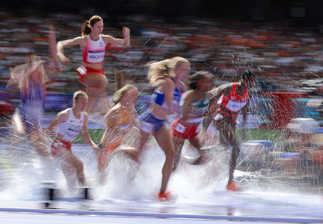 Athletes land in the water jump in a women's 3000m steeplechase heat at the Paris Olympics on Sunday.