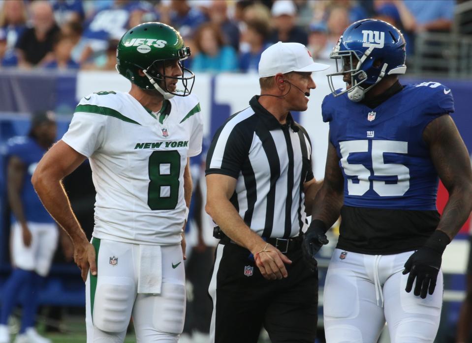 Jets QB Aaron Rodgers and the Giants' Jihad Ward get separated during Saturday's preseason game.