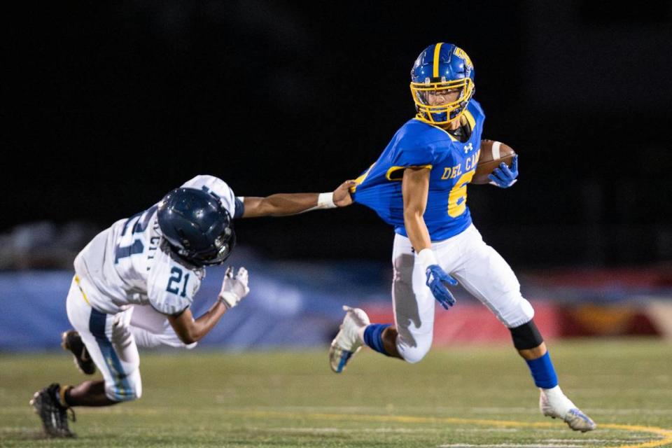 Del Campo Cougars’ running back Jordan Wiley’s (6) power keeps him from getting tackled during the first half of the high school football game at Del Campo High School on Friday in Fair Oaks.