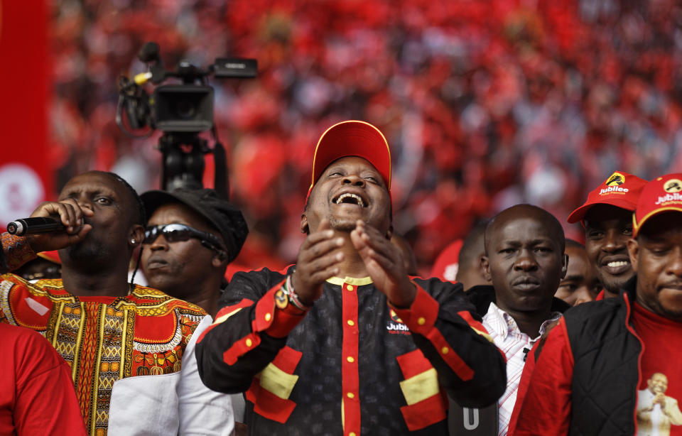 President Uhuru Kenyatta laughs at a rally