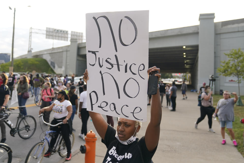 Victoria Gunther marches with Black Lives Matter protesters, Friday, Sept. 25, 2020, in Louisville. Breonna Taylor's family demanded Friday that Kentucky authorities release all body camera footage, police files and the transcripts of the grand jury hearings that led to no charges against police officers who killed the Black woman during a March drug raid at her apartment. (AP Photo/Darron Cummings)