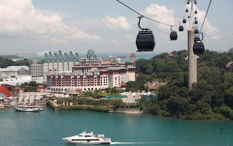 Sentosa island is connected to the mainland by a single bridge and a cable car - Credit:  EDGAR SU/ REUTERS