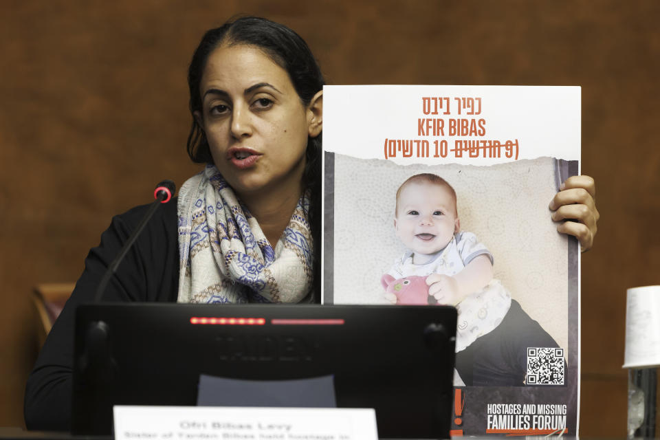 FILE - Ofri Bibas Levy, sister of Yarden Bibas, held hostage in Gaza with his wife, Shiri and two kids, Kfir and Ariel, talks to the media, during a press conference at the European headquarters of the United Nations in Geneva, Switzerland, on Nov. 14, 2023. Kfir Bibas has spent nearly a fifth of his life in Hamas captivity. The 10-month-old was abducted from his home in a southern Israeli kibbutz on Oct. 7, when Palestinian militants snatched about 240 people and dragged them to Gaza. (Salvatore Di Nolfi/Keystone via AP, File)